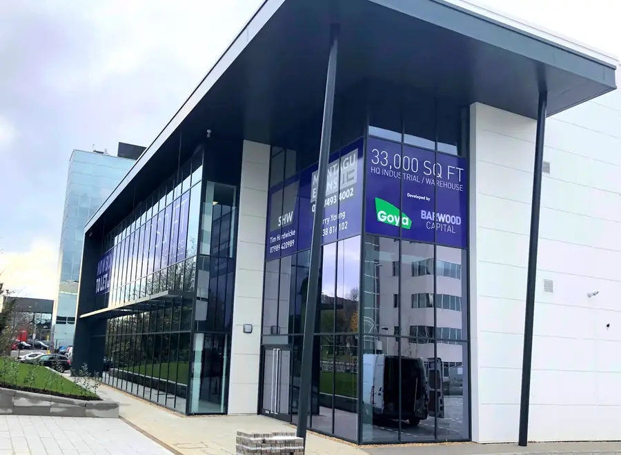 Two storey glazed office corner with a full height curtain walled stairwell