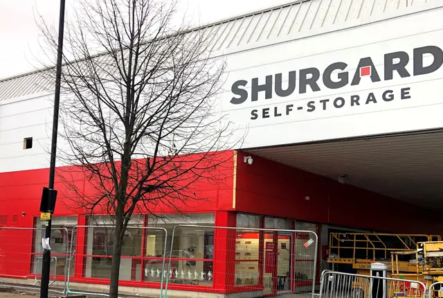 Shurgard self storage frontage with red and white cladding and a glazed reception entrance